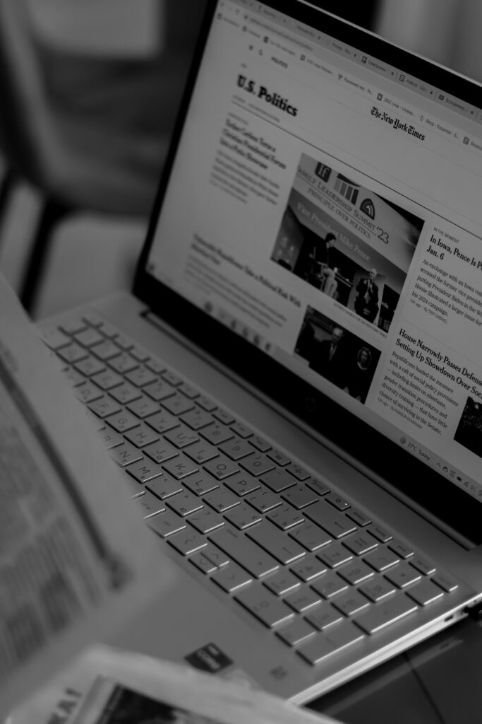 pexels-photo-17706648-17706648 Black and white photo of a laptop showing a news website with focus on U.S. politics section.